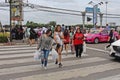 Thai people are walking to cross the street.
